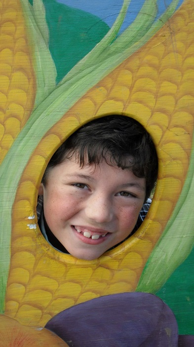 Kid in a corn cob at the Saanich Fair